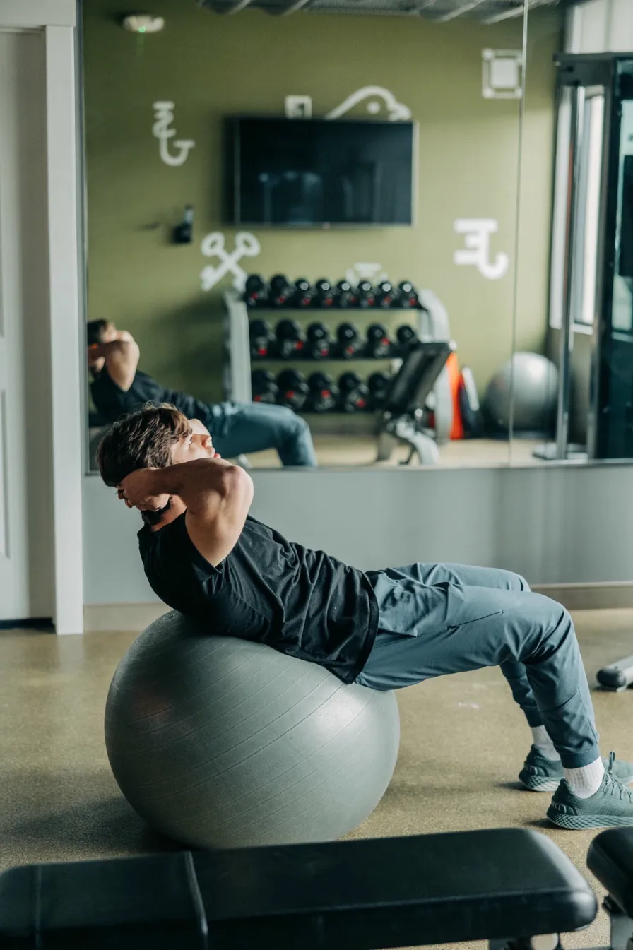 Person exercising on a stability ball in a gym